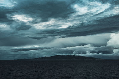 Scenic view of sea against storm clouds