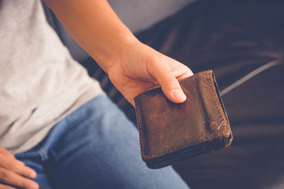 High angle view of woman holding wallet