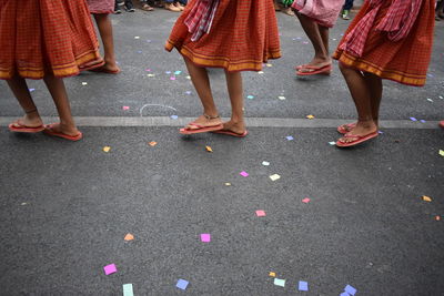 Low section of people dancing on street