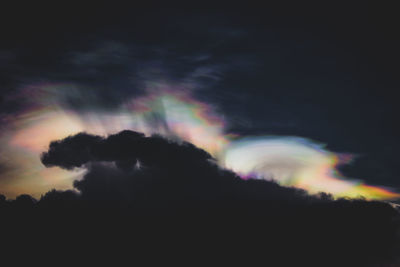 Low angle view of rainbow against sky during sunset