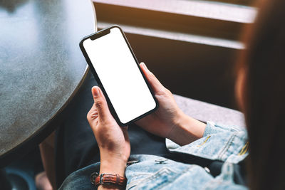 Midsection of man using mobile phone