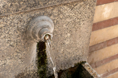 Water flowing from hot minreal spring with mossy basin