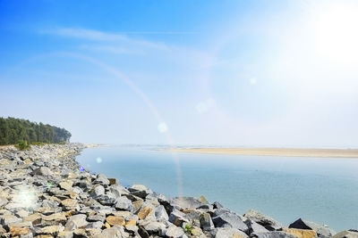 Scenic view of rainbow over sea against sky