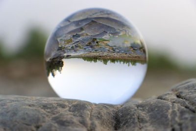Close-up of crystal ball on rock