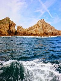 Scenic view of sea and mountain against sky