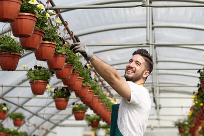 Young man standing in greenhouse