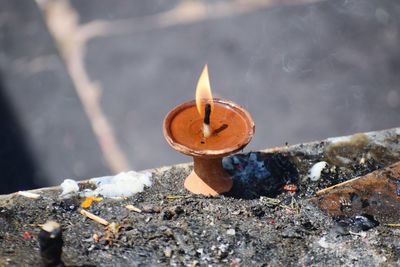 Close-up of lit candles in temple