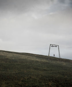 Woman standing on field against sky