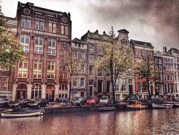 Boats in canal along buildings