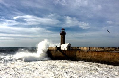 Distance shot of lighthouse against the sky