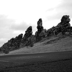 Rock formations on landscape against sky