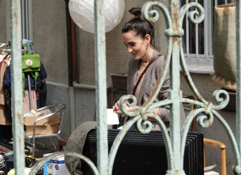 Woman looking at camera while sitting in bus