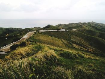 Scenic view of landscape and sea against sky