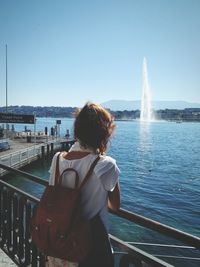 Rear view of woman standing in water