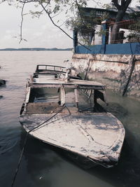 Boat moored on sea against sky