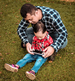 Father and son baby on grass