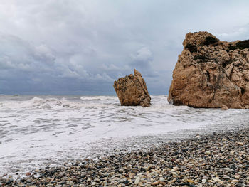 Rocks on beach against sky