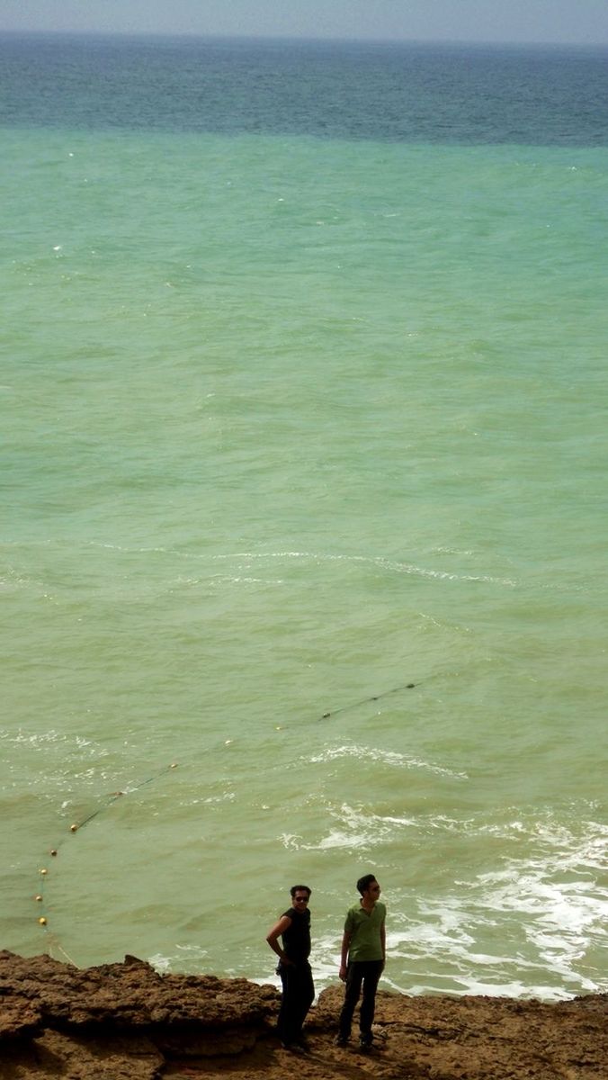 water, lifestyles, sea, leisure activity, togetherness, men, rear view, beach, bonding, person, shore, horizon over water, vacations, love, nature, boys, standing, full length