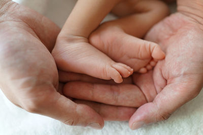 Close-up of couple holding hands