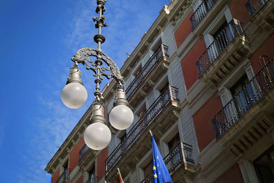 Low angle view of street light against building