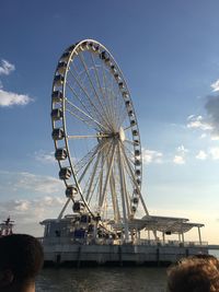 Low angle view of ferris wheel against sky