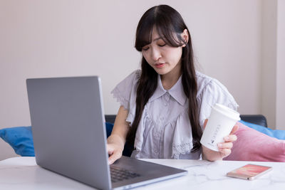 Businesswoman using laptop at office