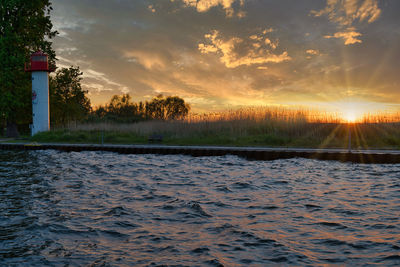 Scenic view of lake against sky during sunset