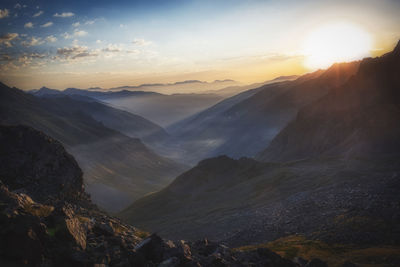 Scenic view of mountains against sky during sunrise.