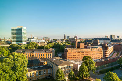 High angle view of buildings in city against clear sky