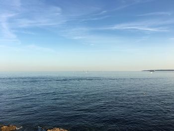 Scenic view of sea against blue sky