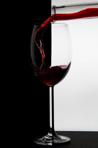 Close-up of wineglass against black background