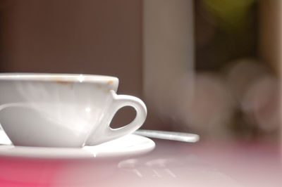 Close-up of coffee cup on table