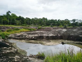 Scenic view of waterfall against sky