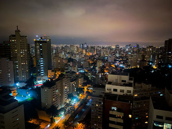 High angle view of illuminated city buildings at night