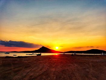 Scenic view of beach against sky during sunset