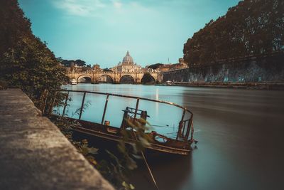 Arch bridge over river against sky