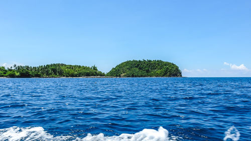Scenic view of sea against blue sky