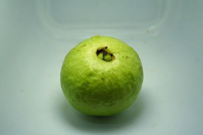 High angle view of apple against green background
