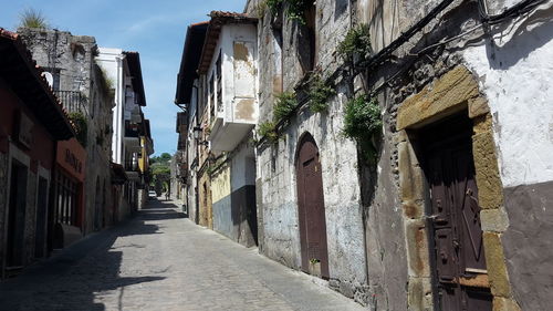 Narrow alley amidst old buildings in town