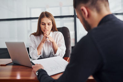 Young woman using laptop at office