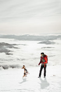 Full length of woman standing on snow