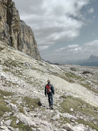 Hiker in the mountains - direction to rifugio kostner, sella group, dolomites, south tyrol, italy 