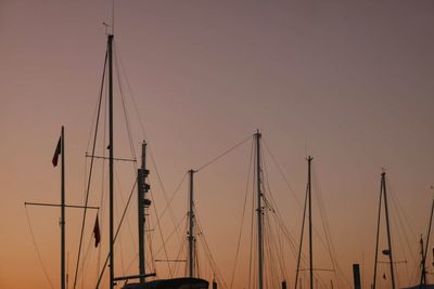 Low angle view of sailboats on sea against sky during sunset