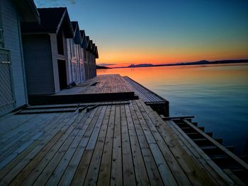 Pier over sea against sky during sunset