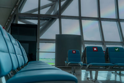 Empty seat in departure lounge at airport terminal. distance for one seat keep distance.