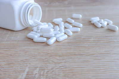 Close-up of white bottles on table