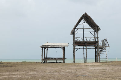 Lifeguard hut on beach against sky