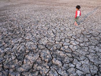 Girl walking on barren landscape