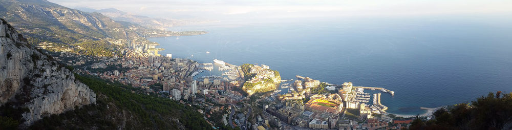 High angle view of townscape by sea against sky