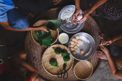 High angle view of people preparing rice cake